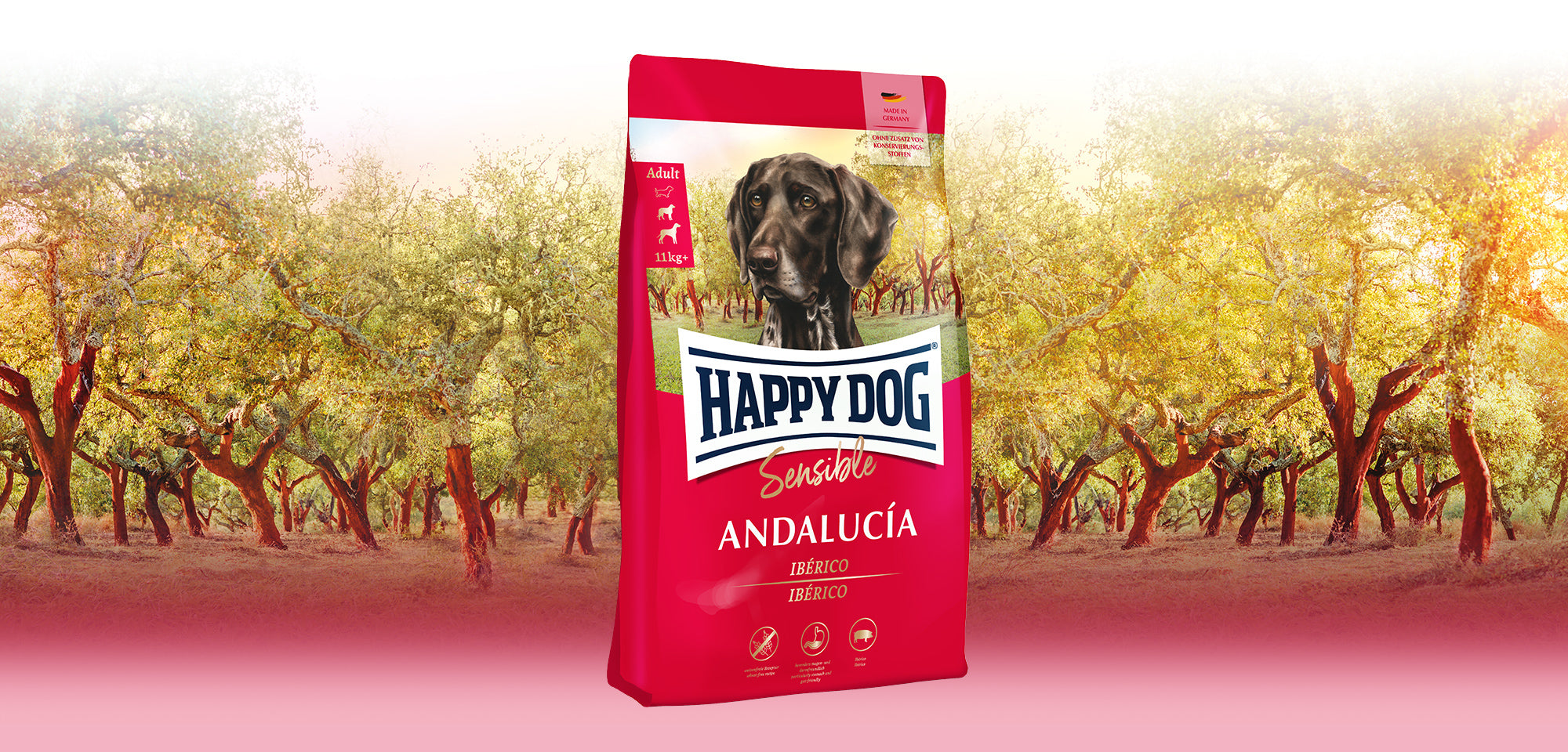 Das Hundefutter Happy Dog Sensible Andalucía, abgebildet vor einem typisch andalusischem Olivenhain.